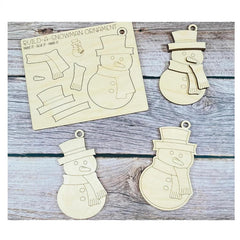 Wooden snowman ornaments and a template on a wooden surface