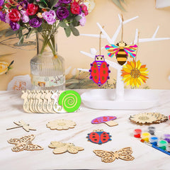 Wooden craft items including ladybugs, flowers, and butterflies on a table with a vase of flowers in the background.