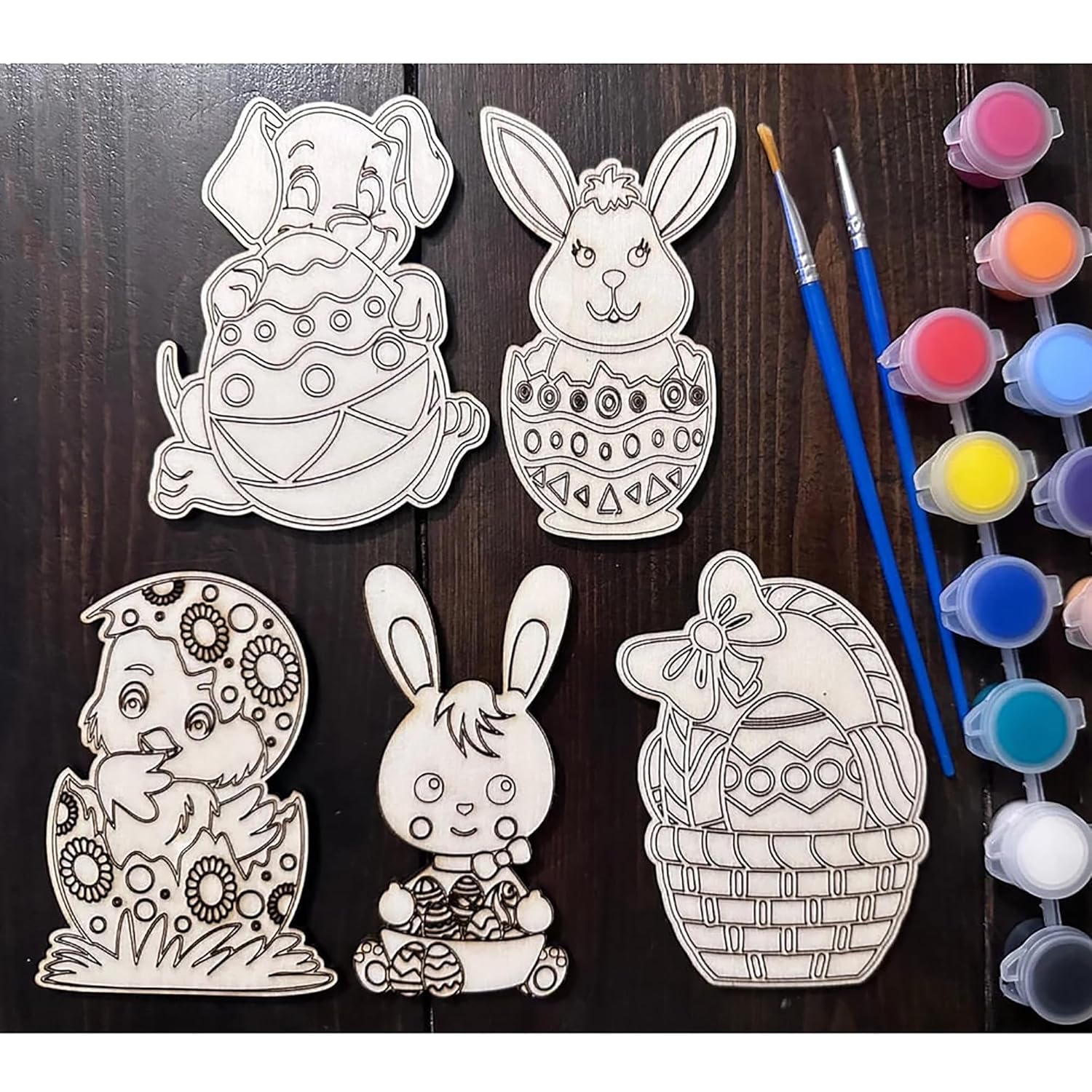 Easter-themed coloring pages with paintbrushes and paint on a wooden surface