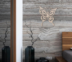 Butterfly decor on a textured wall with vases and a bed in the foreground