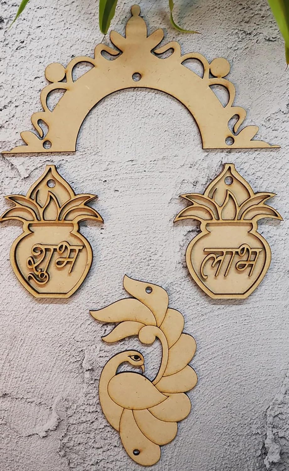 Decorative wooden cutouts with peacock and pot designs on a textured wall background
