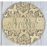 Decorative wall art with butterflies and the word 'hello' on a wooden background