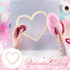 Heart-shaped craft project with pink yarn and tools on a colorful background, suitable for Valentine's Day.
