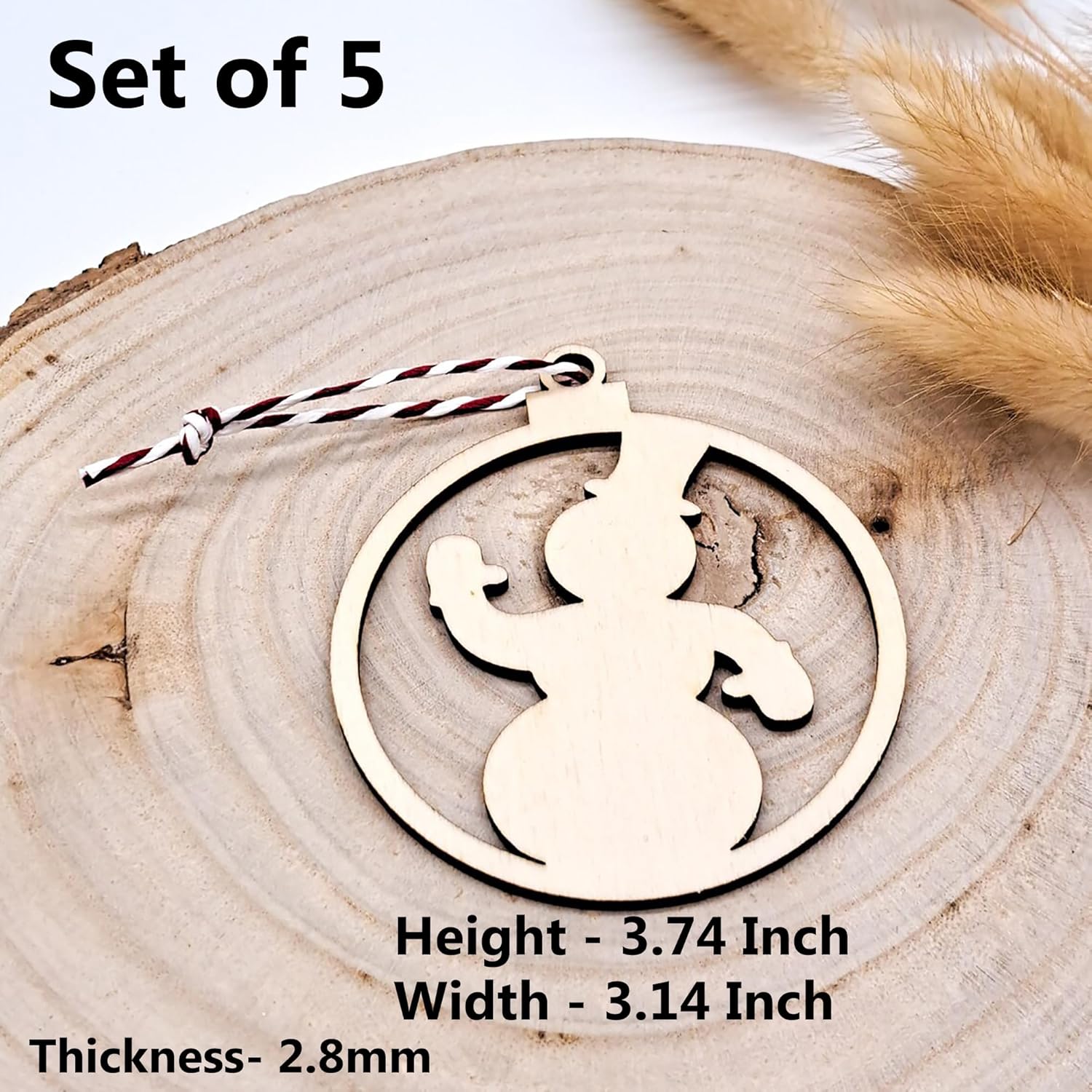 Wooden snowman ornament on a wooden surface with measurements displayed.