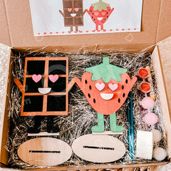 Wooden craft kit with strawberry character and supplies in a box