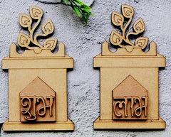 Two wooden wall art pieces with leaf designs on a gray background