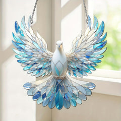 Decorative stained glass dove hanging by a window