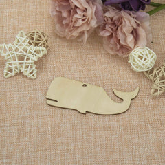 Wooden whale-shaped ornament on a textured fabric background with decorative elements.