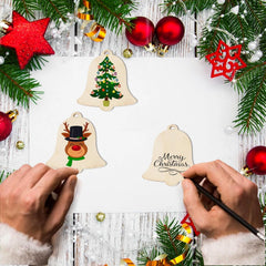 Decorative Christmas ornaments being painted on a festive background with tree branches and red balls.
