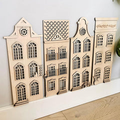 Set of wooden architectural models on a white surface