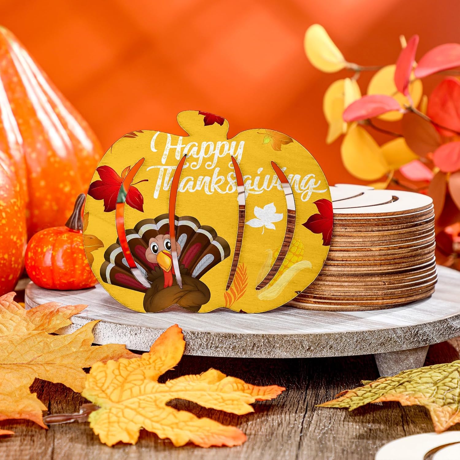 Decorative Thanksgiving plate with a turkey illustration on a wooden table with fall leaves and pumpkins.