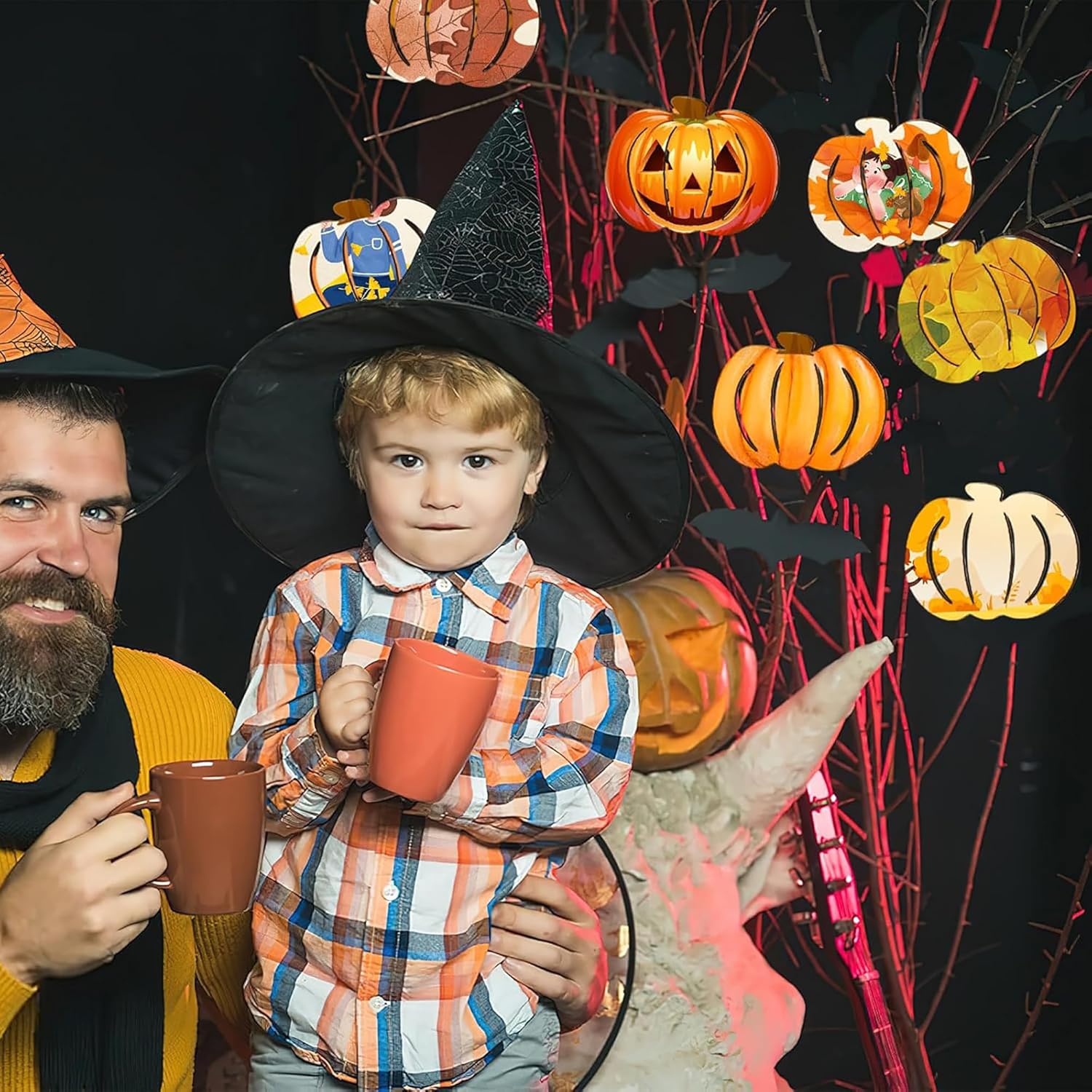 Two people in Halloween costumes with pumpkins and witch hats in the background.