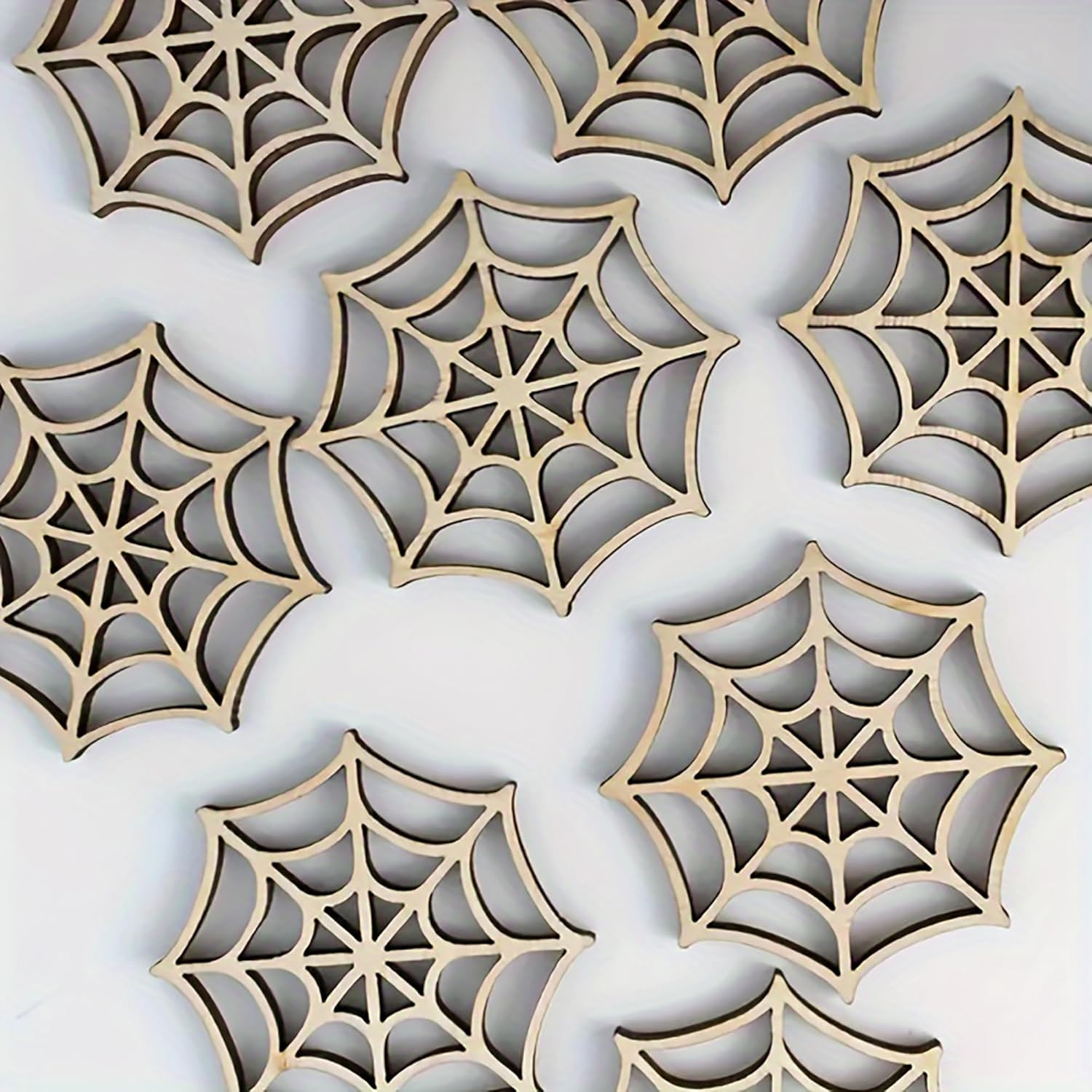 Wooden spider web cutouts on a white background