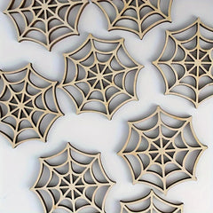 Wooden spider web cutouts on a white background