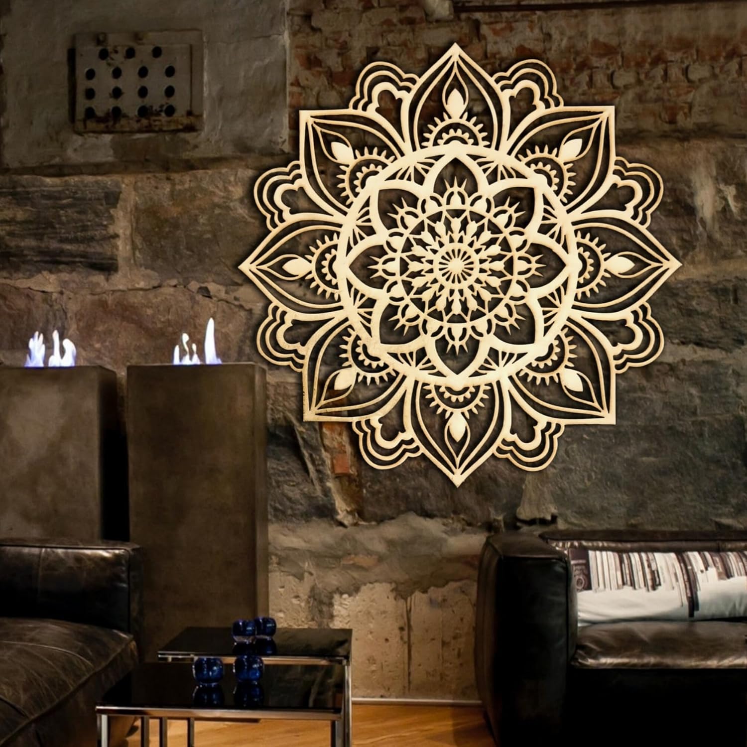 Decorative mandala wall art on a stone wall in a living room setting.