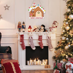 Decorated Christmas fireplace with stockings, tree, and festive decor.