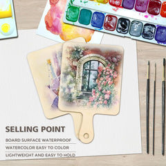 Painting of a floral arch on a wooden board with watercolor set and brushes on a table.