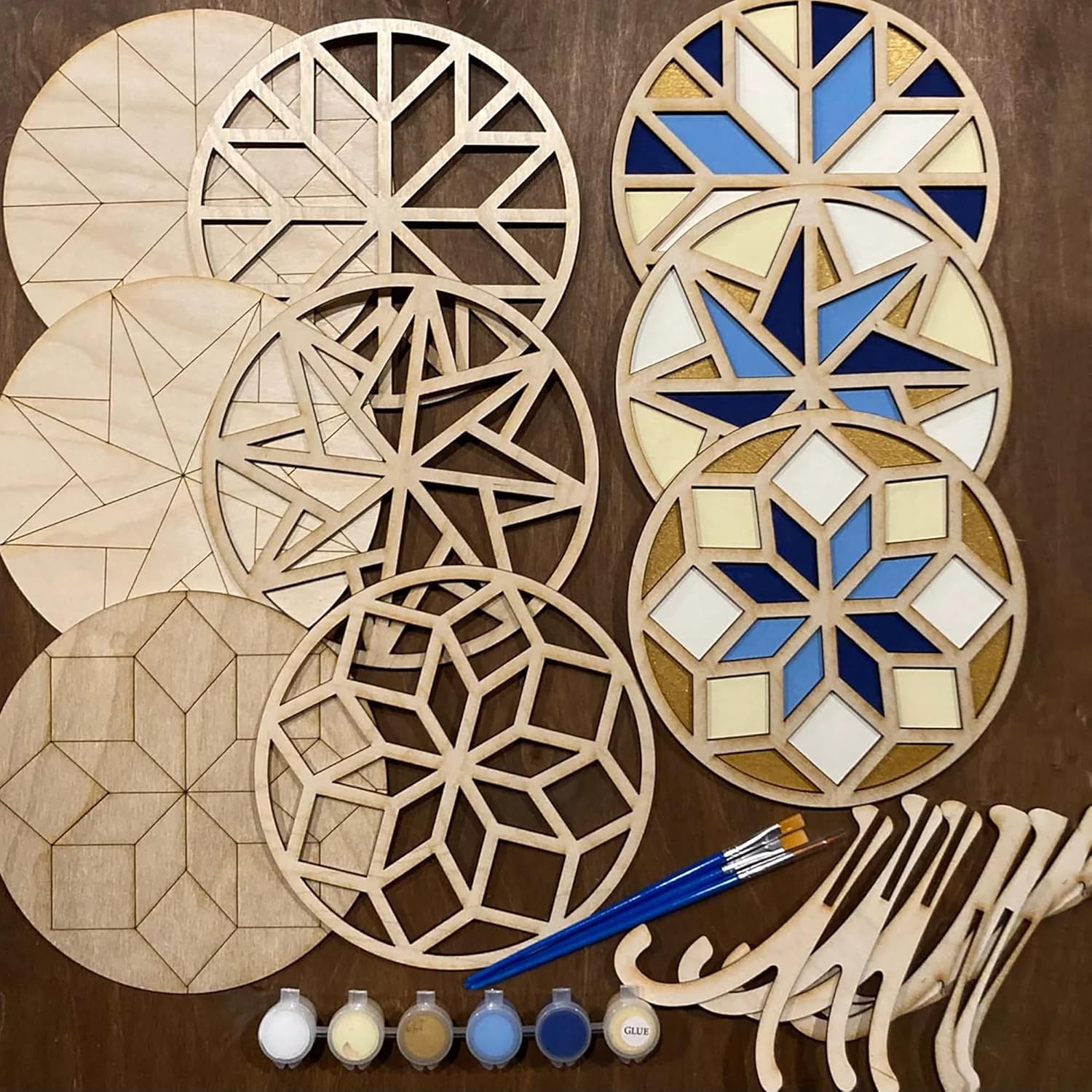 Wooden geometric shapes with paint and brushes on a brown background