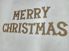 Wooden 'Merry Christmas' decoration on a light background