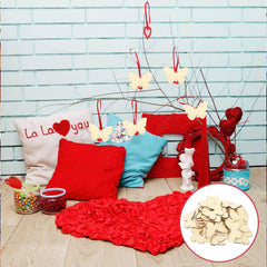 Decorative setup with pillows, a red blanket, and butterfly decorations against a light blue brick wall.