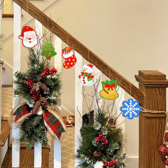 Decorative Christmas ornaments on a staircase with wreaths and festive elements.