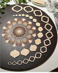 Decorative wooden pieces arranged on a round black surface with a geometric pattern.