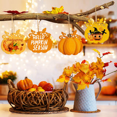Decorative items for Thanksgiving with pumpkins, leaves, and a branch in a warm setting.