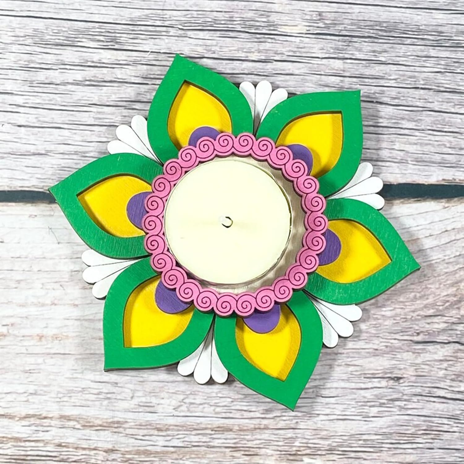 Decorative wall hanging with a floral design on a wooden surface