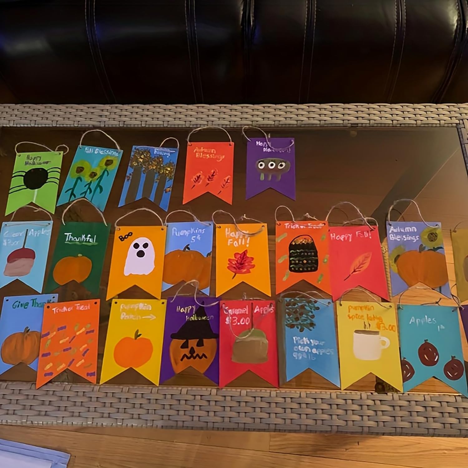Set of colorful Halloween-themed paper bags on a woven surface.