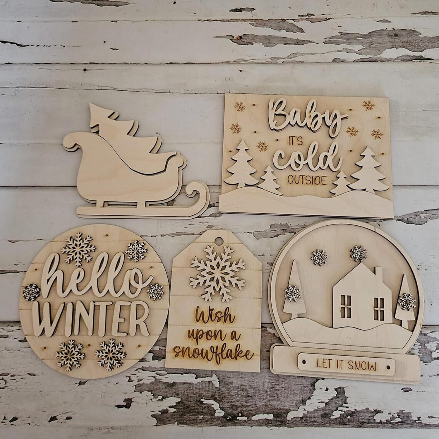 Set of wooden winter-themed decorations on a rustic wooden background