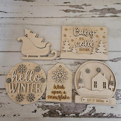 Set of wooden winter-themed decorations on a rustic wooden background
