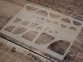 Stencil with geometric shapes on a wooden surface