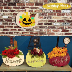 Decorative pumpkin signs with floral designs and text on a brick wall background.