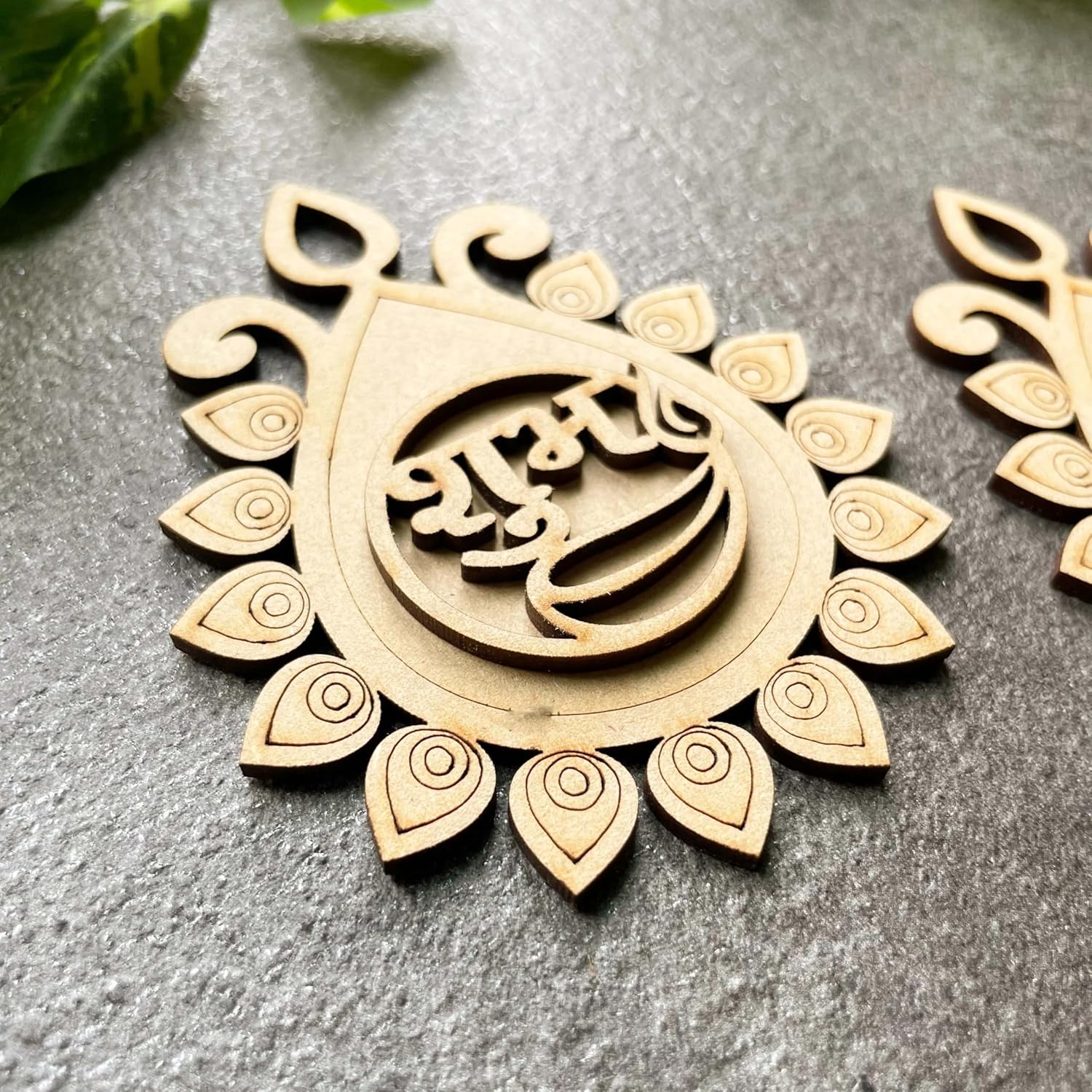 Decorative wooden piece with intricate design on a gray surface
