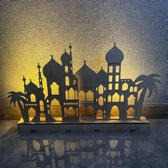 Decorative lamp with architectural design and palm trees on a textured surface