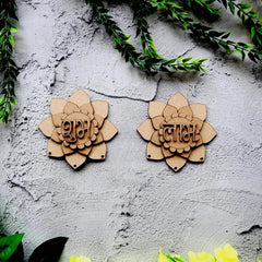 Two wooden lotus-shaped decorations with engraved text on a textured wall.