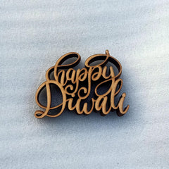 Wooden 'Happy Diwali' decoration on a light blue background