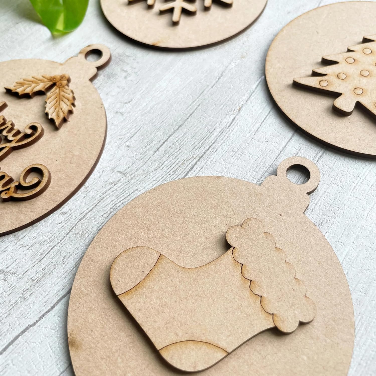 Wooden Christmas ornaments on a light wooden surface