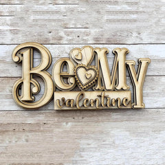 Wooden decorative sign with 'Be My Valentine' text on a wooden background