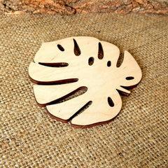 Wooden leaf-shaped coaster on a textured fabric surface