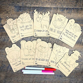 Coloring cards with animal illustrations and markers on a wooden surface