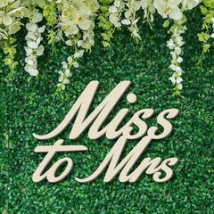 Decorative sign with 'Miss to Mrs' text on a green floral background