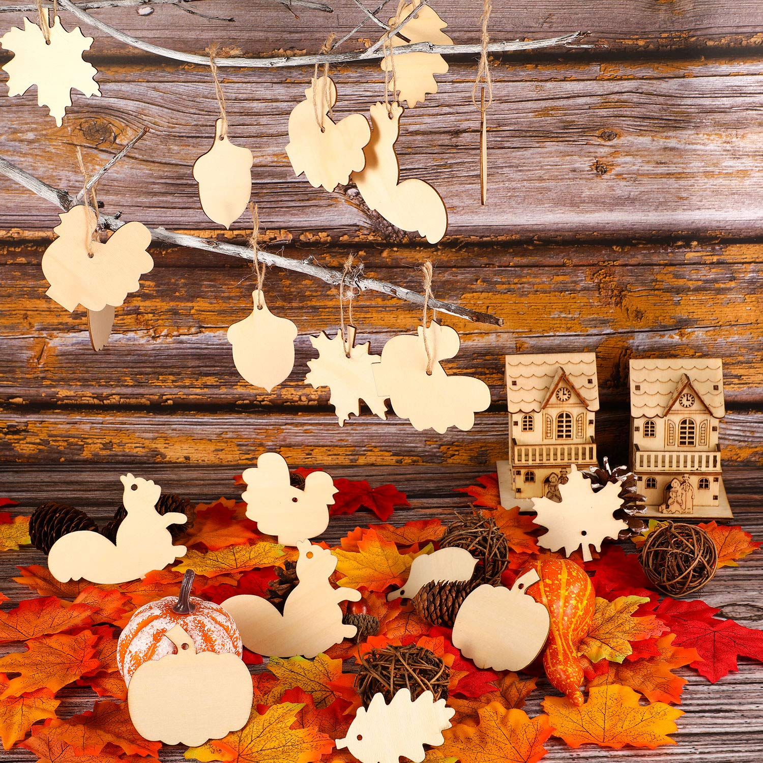 Wooden autumn-themed decorations including pumpkins, leaves, and houses on a rustic wooden background.
