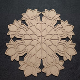 Decorative wooden snowflake cutout on a black background