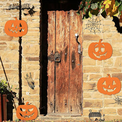 Decorative Halloween scene with pumpkins, cobwebs, and a wooden door on a stone wall.