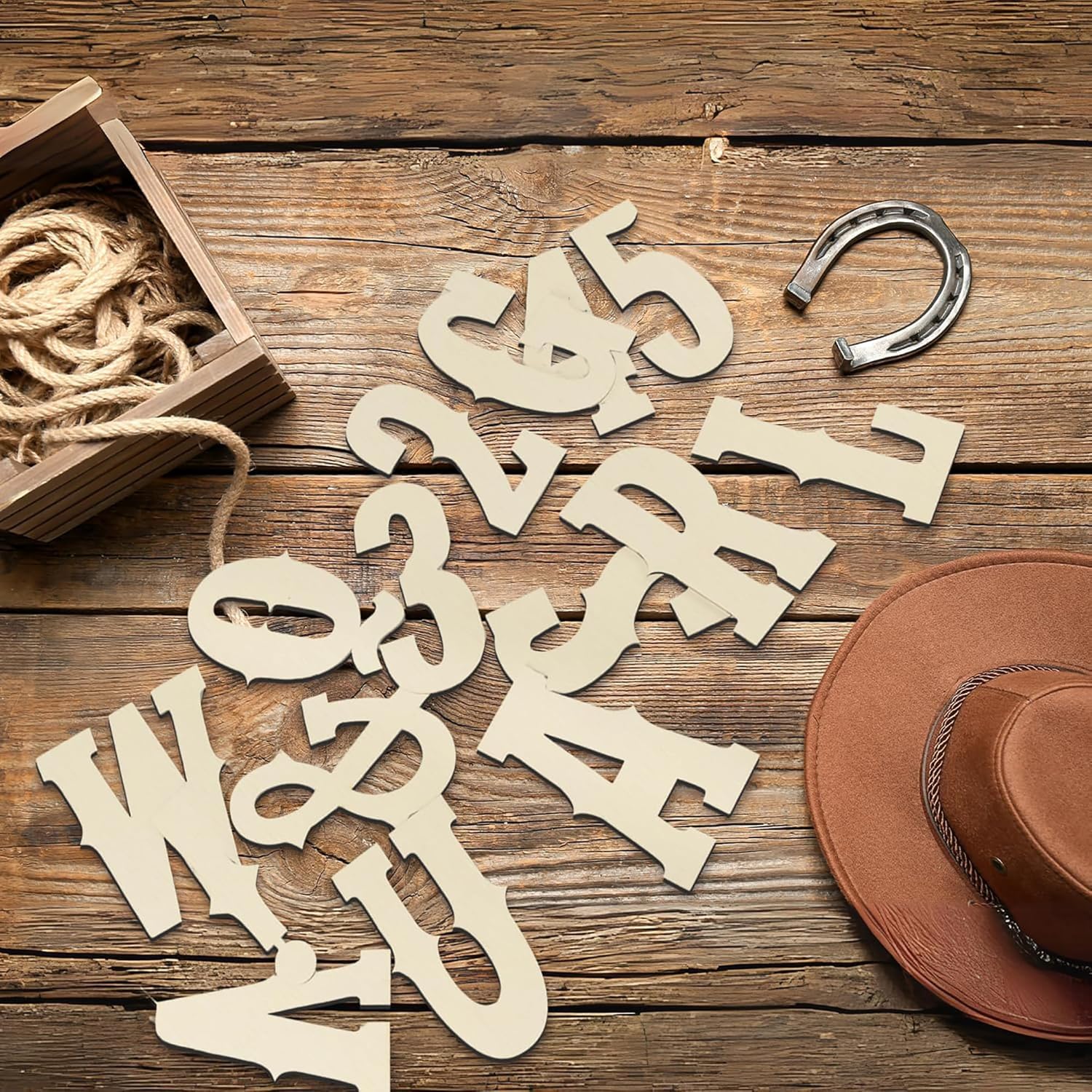 Wooden letters and numbers on a rustic wooden surface with a horseshoe and rope.