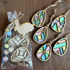 Decorative wooden ornaments with geometric patterns on a wooden surface