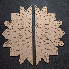 Two beige decorative snowflake shapes on a black background