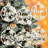 Decorative Christmas ornaments with motivational phrases on a Christmas tree.
