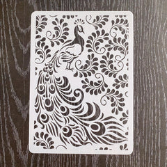 Decorative stencil with peacock design on a wooden surface